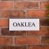 Granite House Sign 25.5 x 10cm 1 Line with sandblasted and painted background